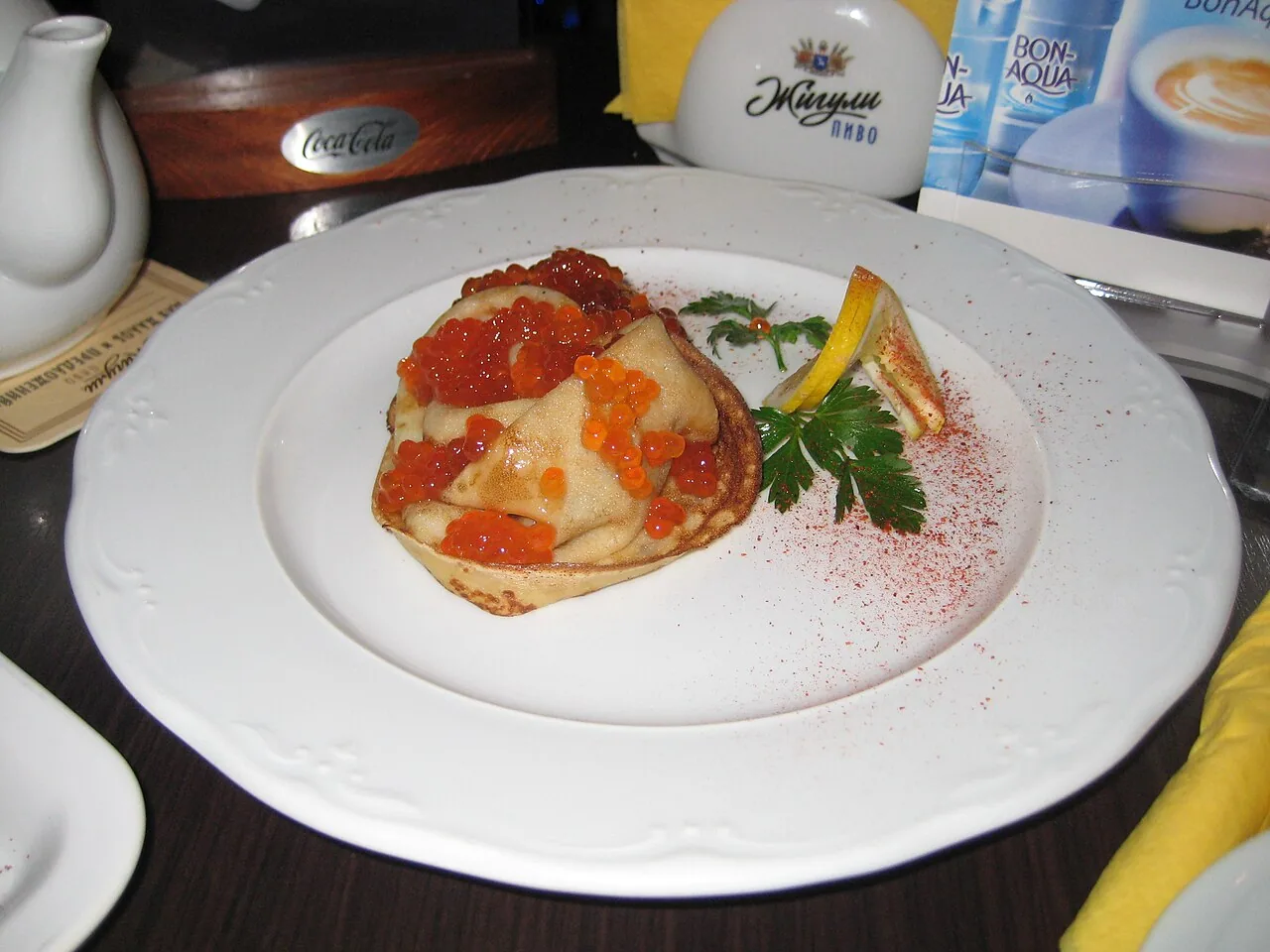 A thin blin pancake served with red caviar