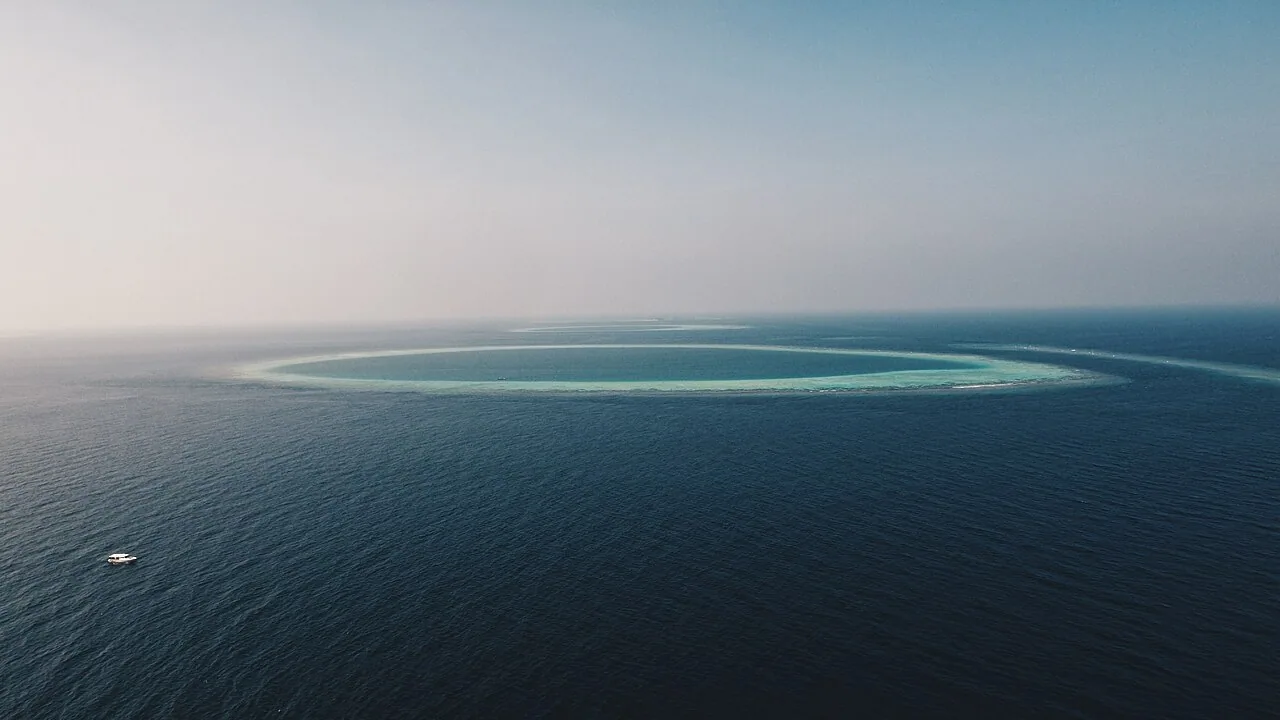Aerial view of Bathalaa island and its surrounding reef in North Ari Atoll, Maldives